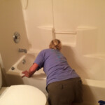cleaner polishing a bathtub
