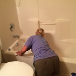 cleaner polishing a bathtub